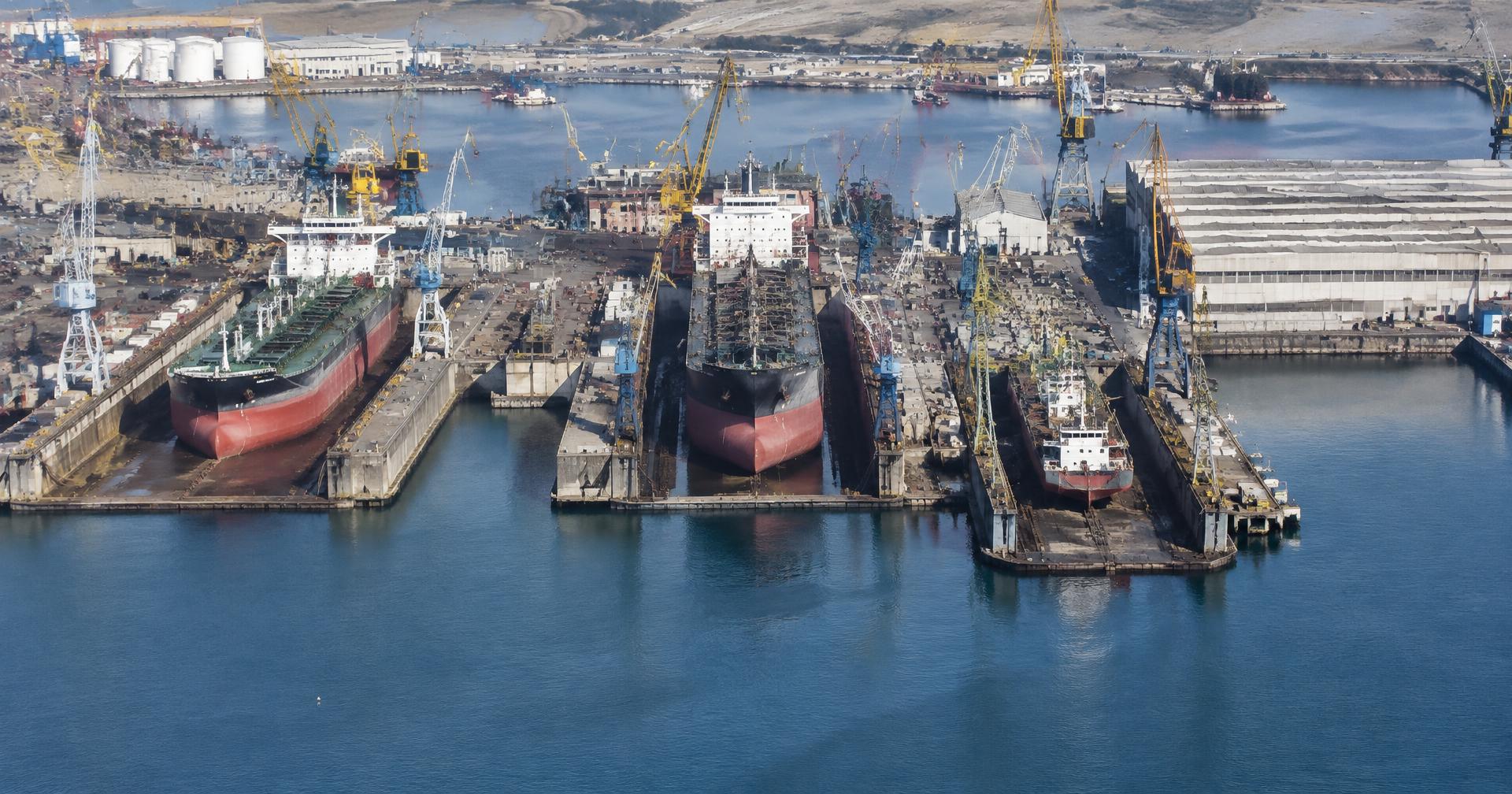 Aerial view of a ship repair yard with vessels in dock